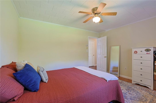 bedroom featuring ceiling fan and ornamental molding