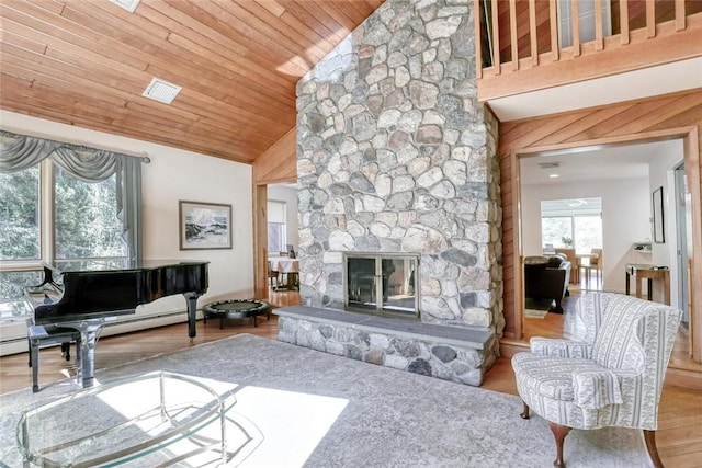 living room with wood ceiling, wooden walls, hardwood / wood-style flooring, high vaulted ceiling, and a stone fireplace