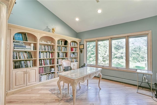 office featuring baseboard heating, light hardwood / wood-style flooring, and vaulted ceiling