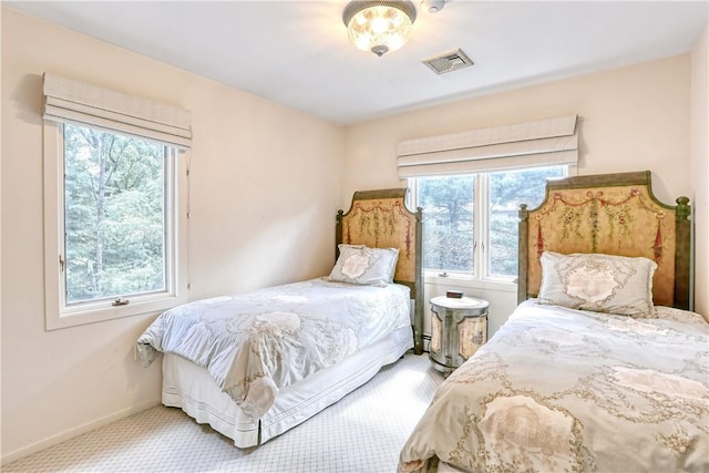 carpeted bedroom with multiple windows