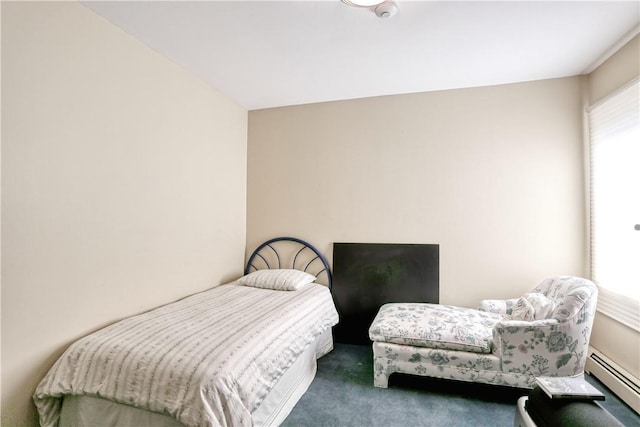 carpeted bedroom featuring a baseboard heating unit