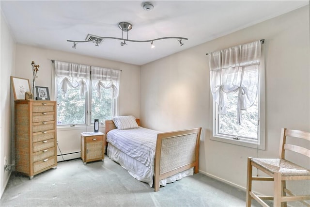 carpeted bedroom featuring a baseboard radiator