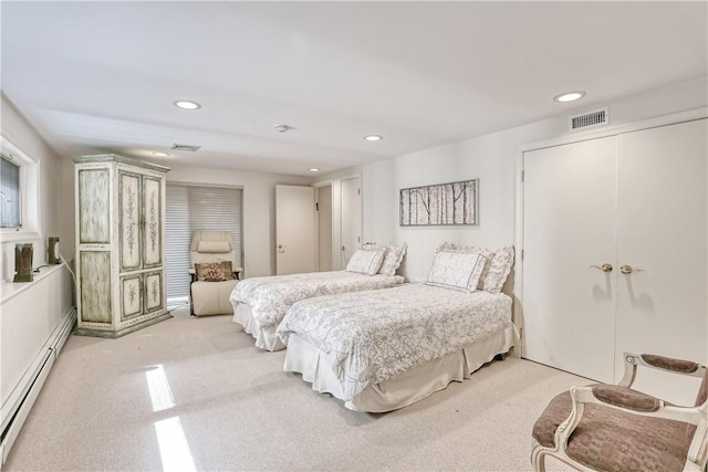 carpeted bedroom featuring baseboard heating