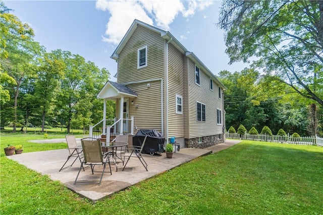 back of house featuring a patio area and a yard