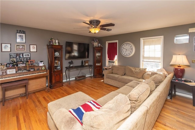 living room with hardwood / wood-style flooring, a baseboard radiator, and ceiling fan