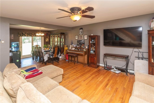 living room with hardwood / wood-style flooring, ceiling fan with notable chandelier, and baseboard heating