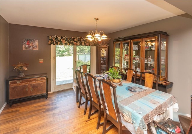 dining area featuring a chandelier and wood-type flooring