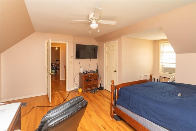 bedroom featuring ceiling fan, lofted ceiling, and light hardwood / wood-style flooring