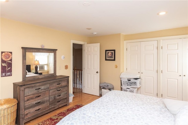 bedroom with light hardwood / wood-style floors and a closet