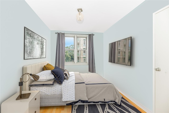 bedroom with hardwood / wood-style flooring