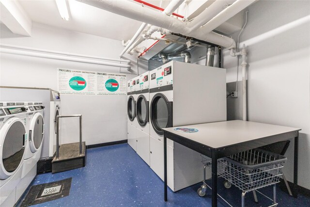 clothes washing area featuring washer and clothes dryer