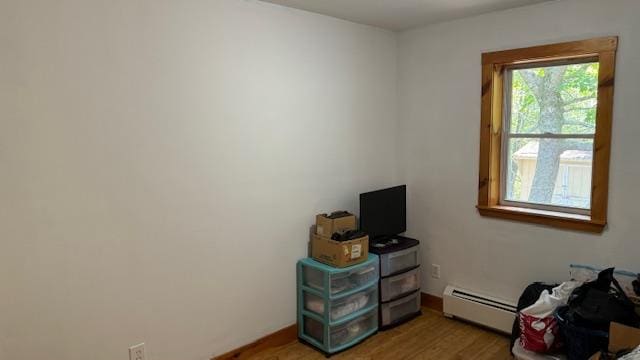 miscellaneous room with hardwood / wood-style flooring and baseboard heating