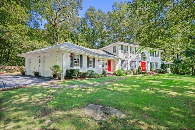 view of front of property with a garage and a front lawn