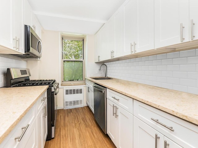 kitchen featuring white cabinetry, sink, and appliances with stainless steel finishes