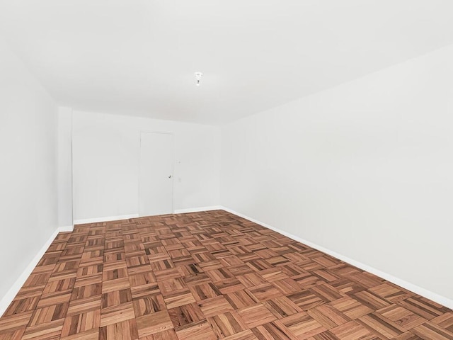 empty room with dark parquet floors