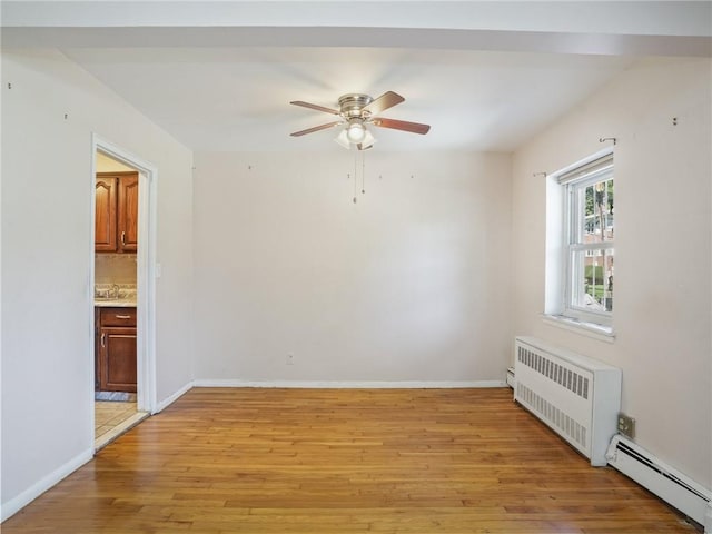 empty room featuring light wood-type flooring, a baseboard radiator, radiator, and ceiling fan