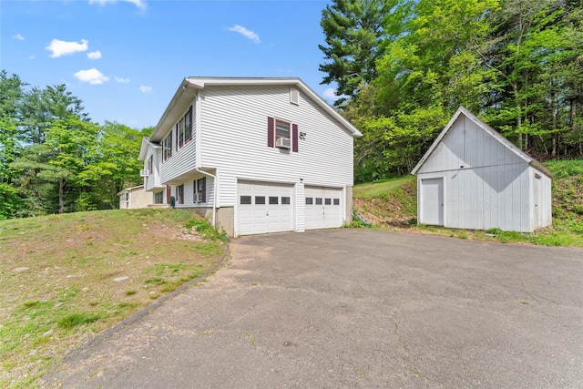 47 Riverside Rd, Newtown, CT 06482 - view of property exterior featuring asphalt driveway, an attached garage, and cooling unit