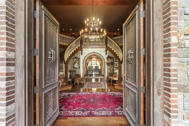 interior space featuring wood-type flooring and a notable chandelier