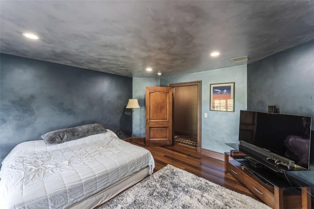 bedroom with dark hardwood / wood-style floors