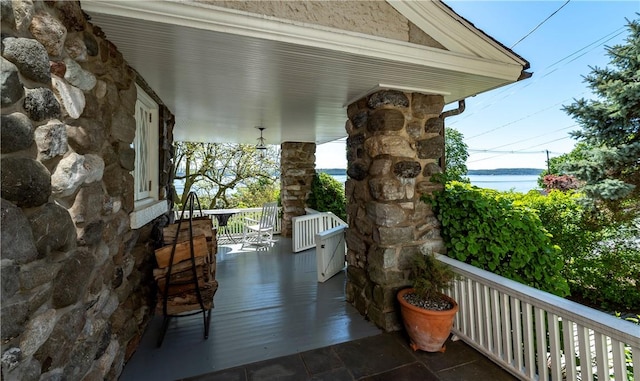 exterior space with covered porch and a water view