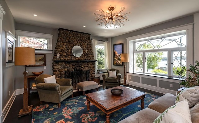 sitting room with a fireplace, hardwood / wood-style flooring, and plenty of natural light