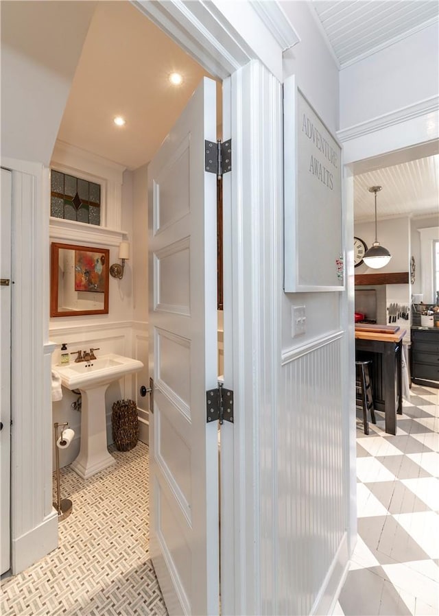 bathroom with crown molding and sink