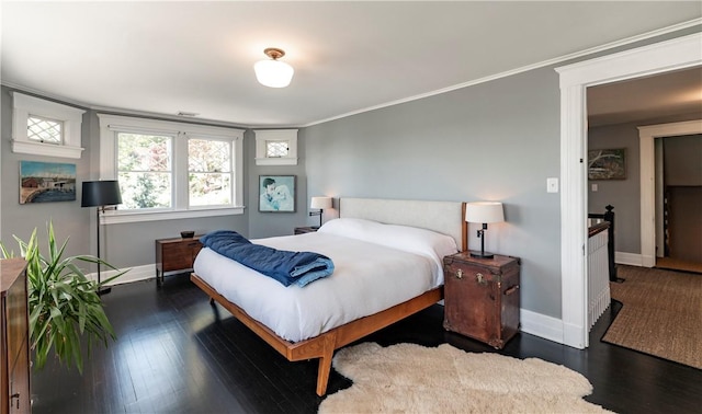 bedroom with crown molding and dark wood-type flooring