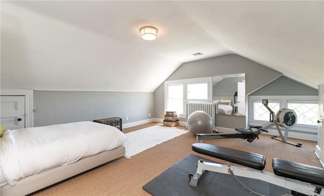 bedroom with light colored carpet and vaulted ceiling