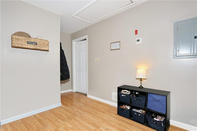 hall featuring electric panel and hardwood / wood-style flooring