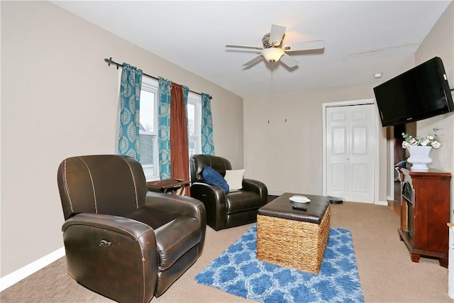 carpeted living room with ceiling fan