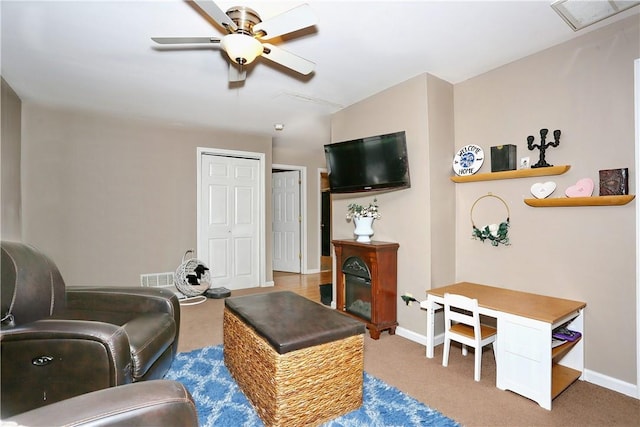 living room featuring carpet floors and ceiling fan