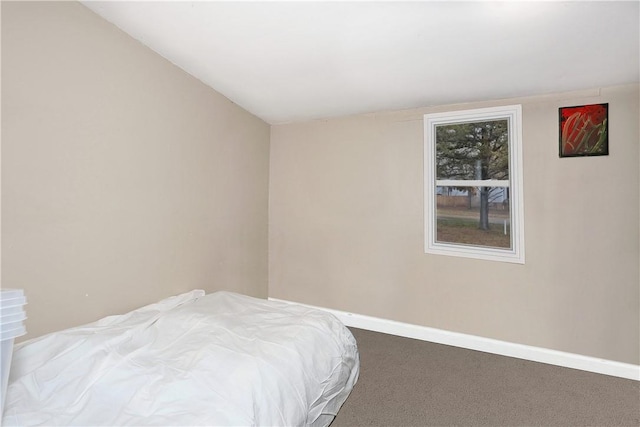 bedroom featuring carpet flooring and vaulted ceiling