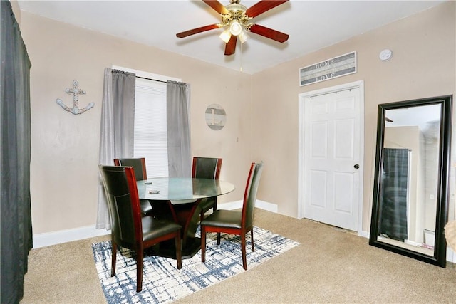 carpeted dining space featuring ceiling fan