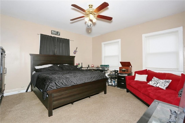 bedroom featuring light carpet and ceiling fan