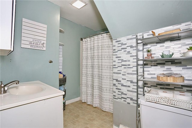 bathroom featuring decorative backsplash, vanity, and a shower with shower curtain