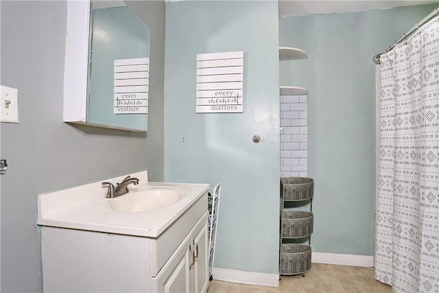 bathroom featuring tile patterned flooring, vanity, and curtained shower