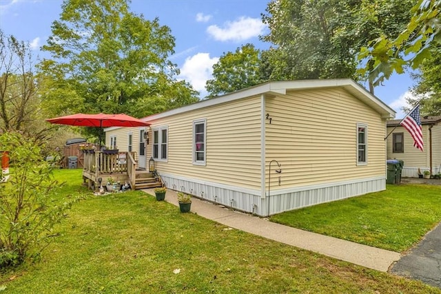 view of property exterior featuring a yard and a wooden deck