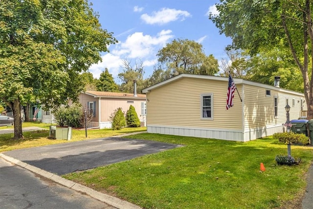 view of property exterior with a lawn