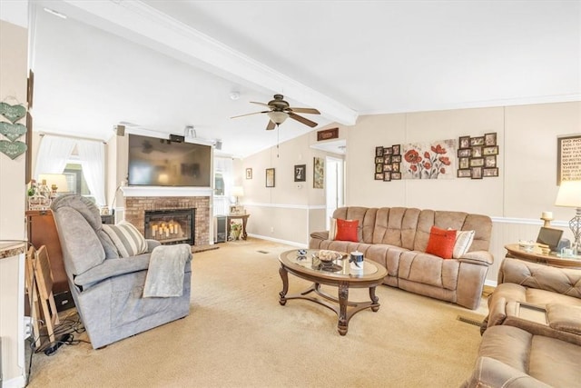 carpeted living room with ceiling fan, a fireplace, and lofted ceiling with beams