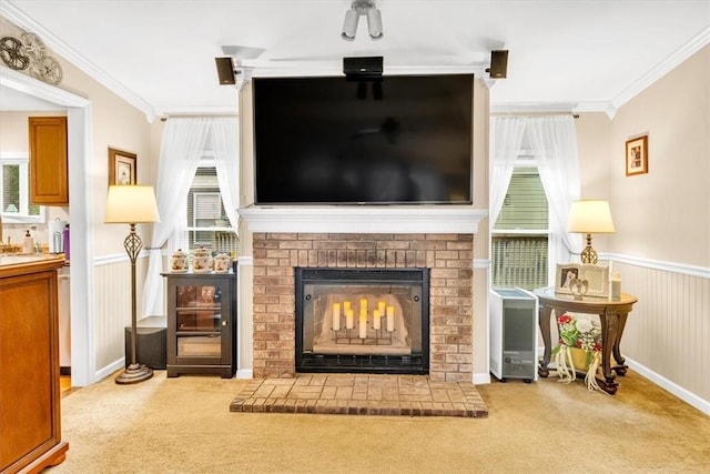 living area featuring crown molding, a fireplace, and light carpet