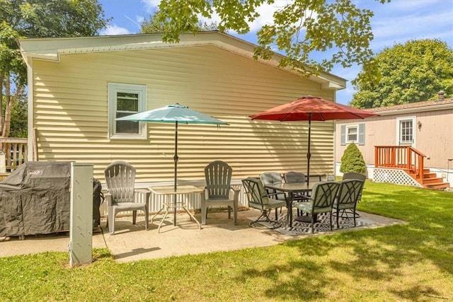 back of house featuring a lawn and a patio area