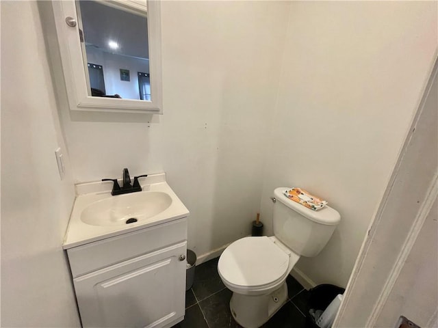 bathroom with tile patterned floors, vanity, and toilet