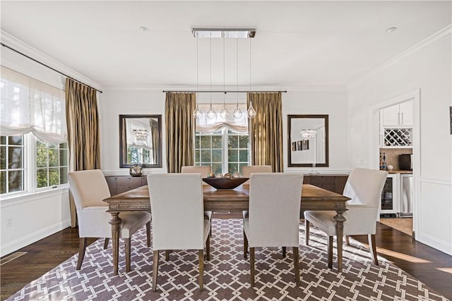 dining area with beverage cooler, baseboards, a bar, dark wood finished floors, and crown molding