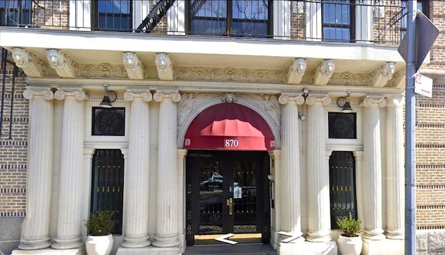 entrance to property with a balcony and french doors