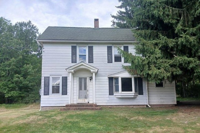 colonial inspired home with a front yard