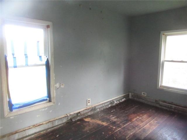 spare room with dark wood-type flooring