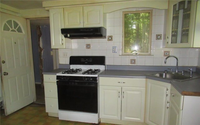 kitchen with backsplash, white cabinets, sink, and white gas range oven