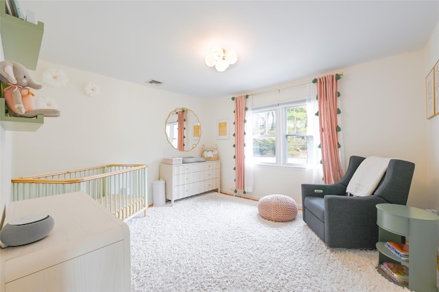 bedroom with visible vents and carpet flooring