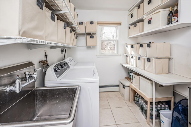 washroom with laundry area, light tile patterned flooring, separate washer and dryer, a sink, and baseboard heating