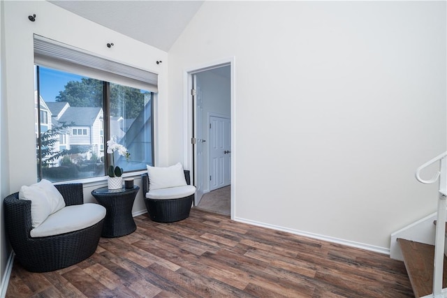 living area featuring dark hardwood / wood-style flooring and vaulted ceiling